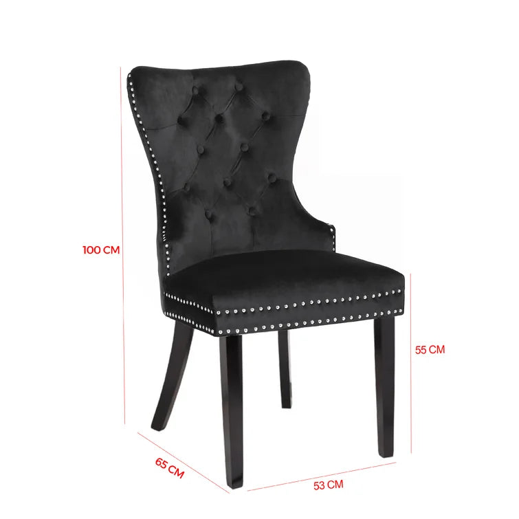 Elegant black velvet dining chair with tufted back and silver nailhead trim