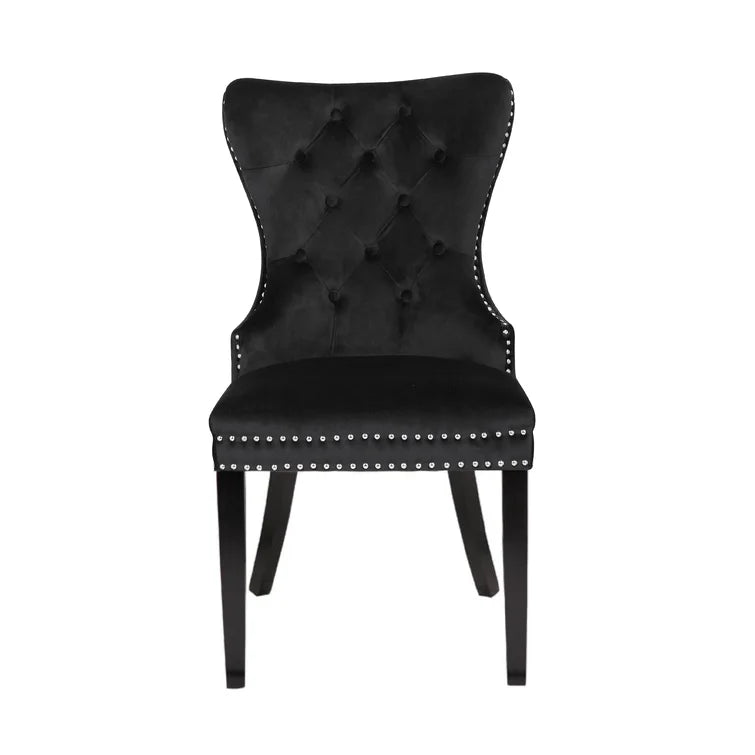 Black velvet tufted dining chair with silver nailhead trim