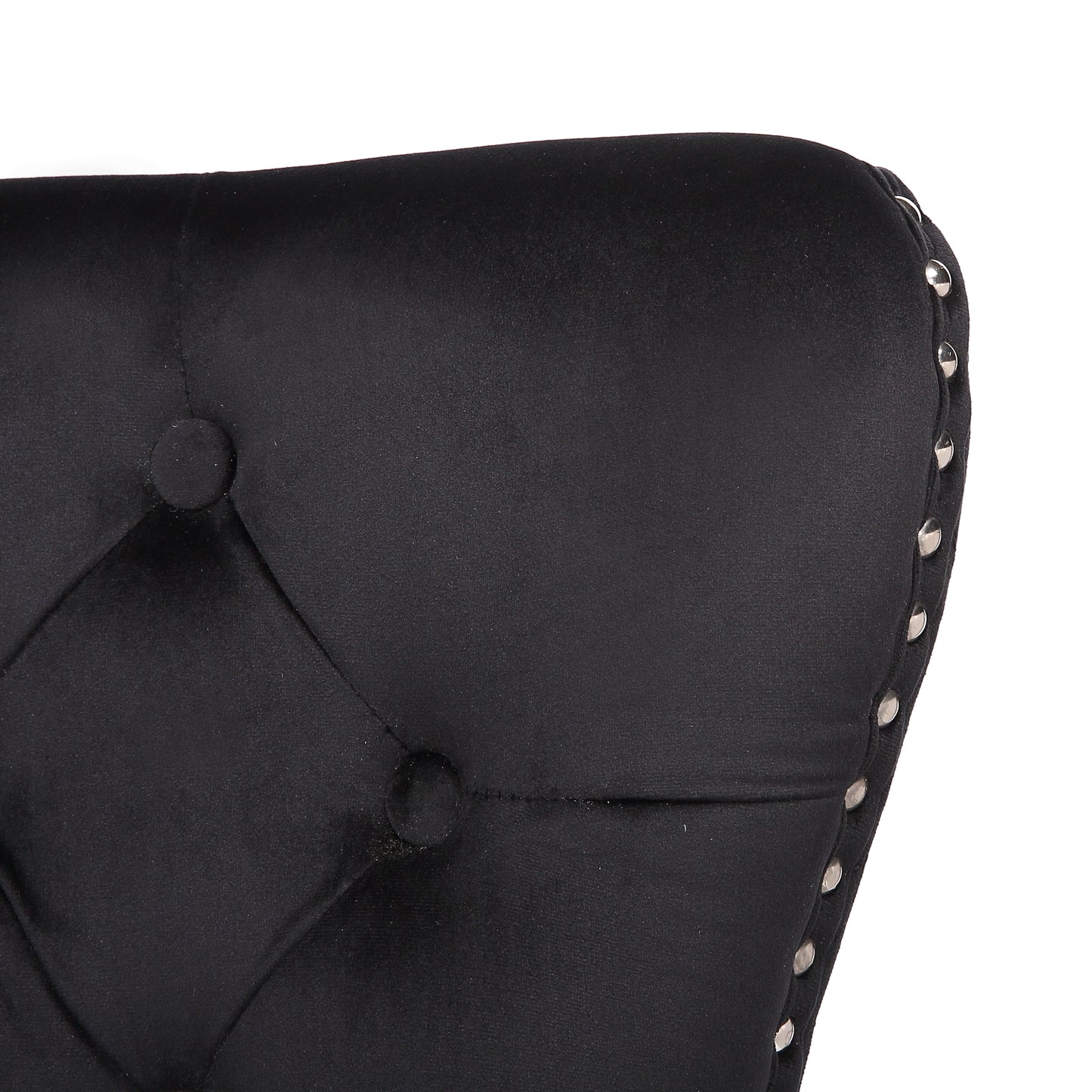 Black velvet tufted accent chair detail with silver nailhead trim