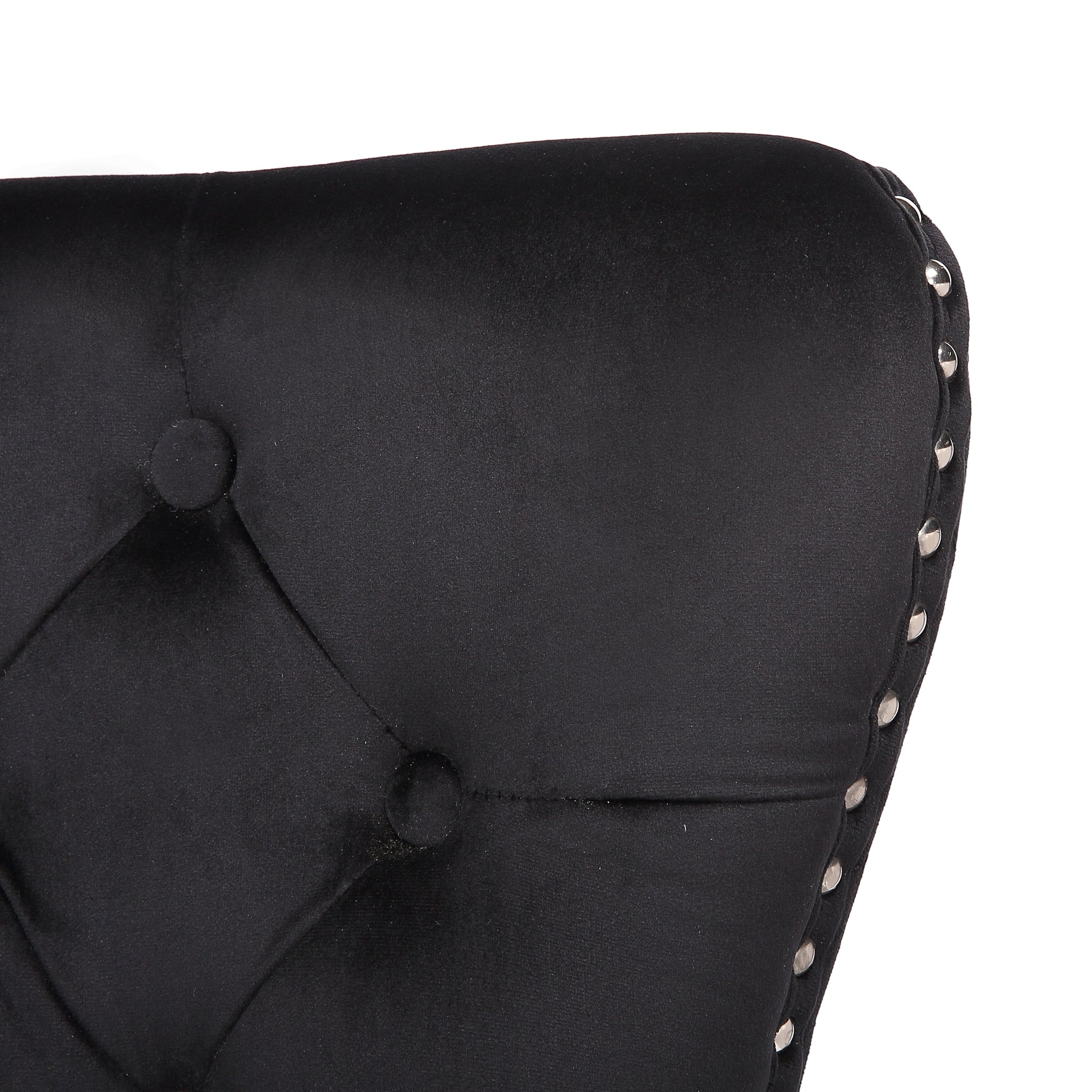 Black velvet tufted accent chair detail with silver nailhead trim