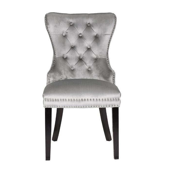 Silver velvet accent chair with button tufting and nailhead trim details