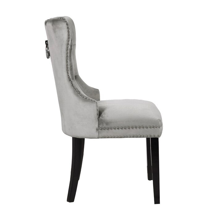 Elegant grey velvet dining chair with silver studding and a ring pull accent