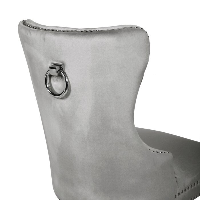 Silver velvet dining chair with silver studding and a ring back detail