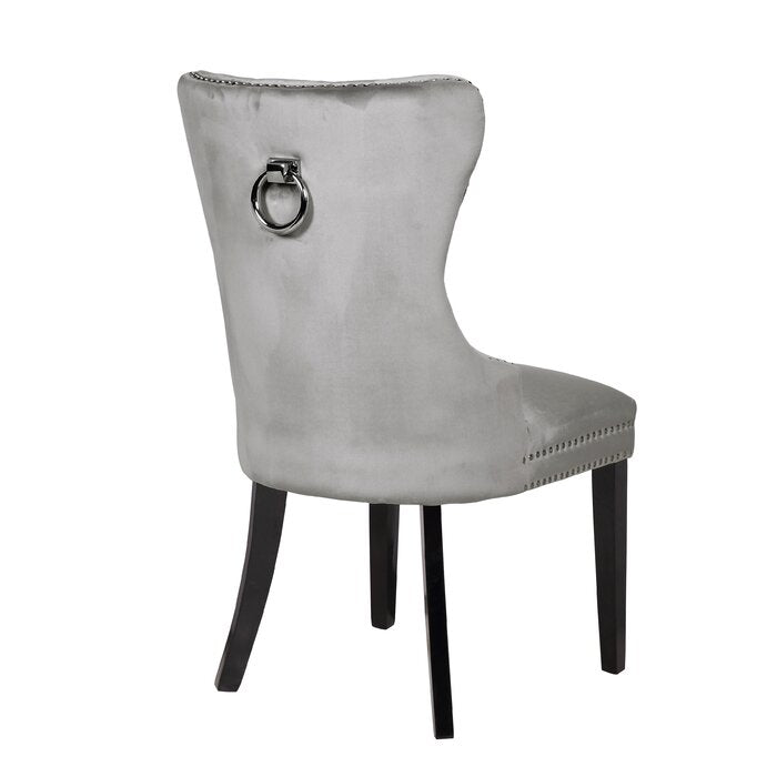 Silver velvet dining chair with ornate studding and a back ring pull