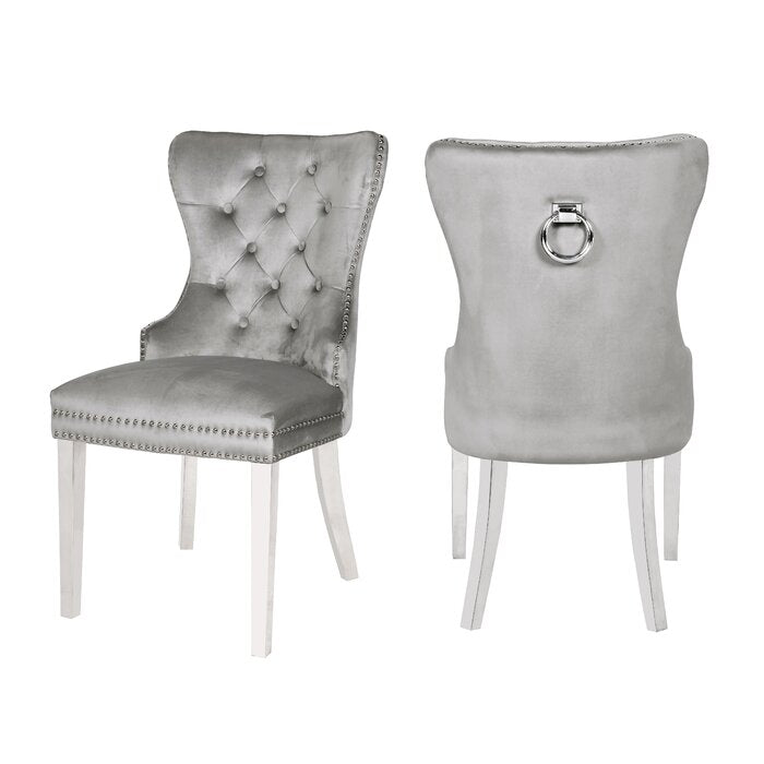 Elegant grey velvet dining chairs with tufted back and silver studding detail