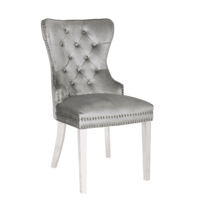 Silver velvet dining chair with tufted back and nailhead trim