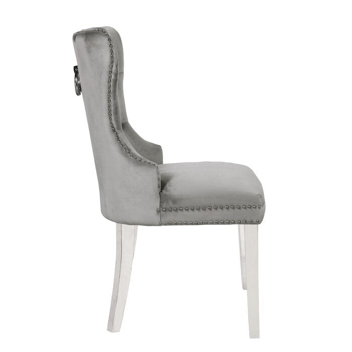 Elegant grey velvet dining chair with silver stud detailing and ring pull