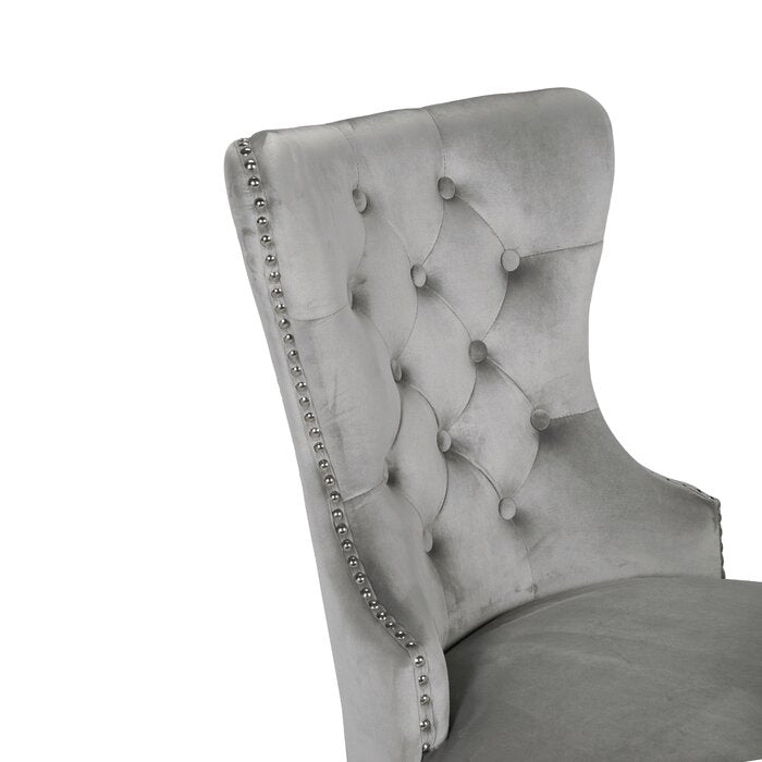 Silver velvet dining chair with diamond tufting and silver nailhead trim