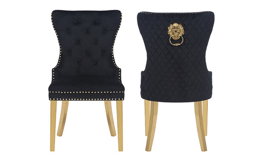 Black velvet dining chair with tufted back and gold nailhead trim