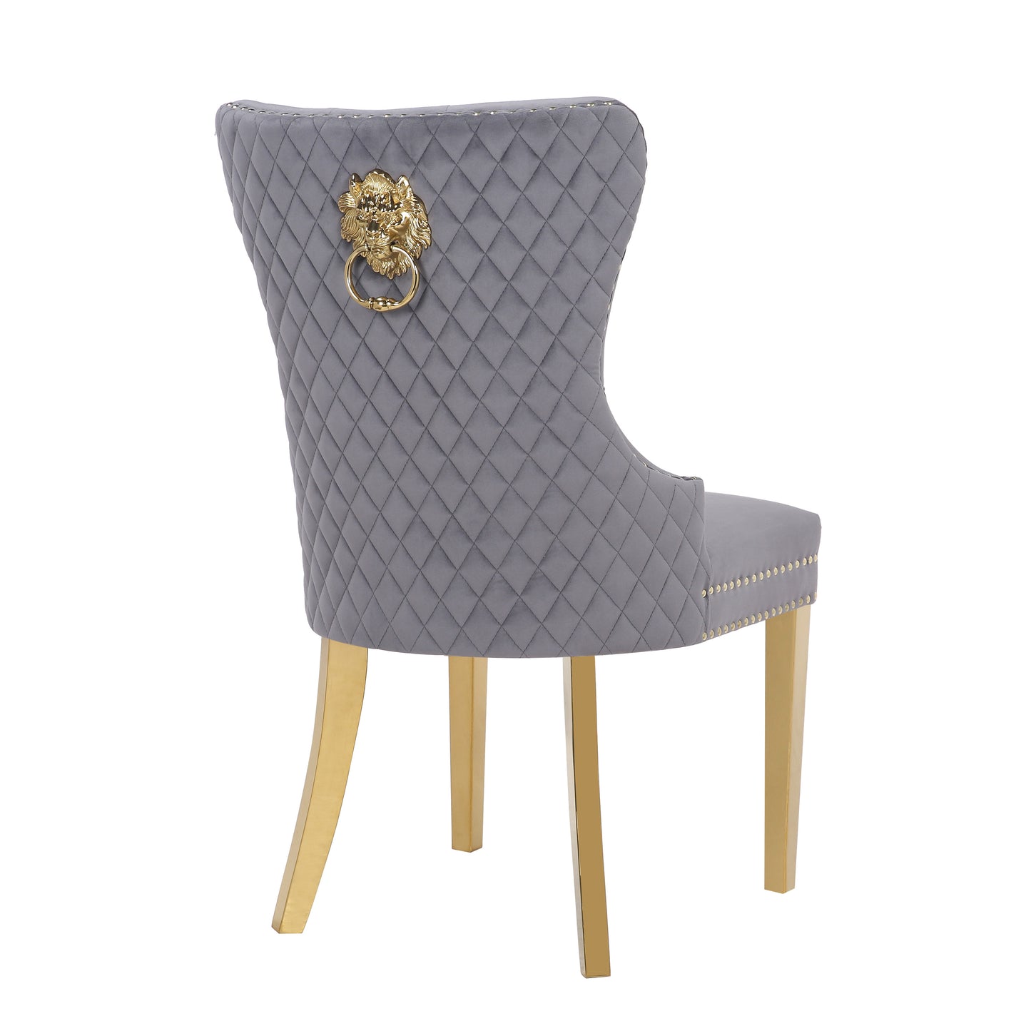 Grey velvet dining chair with diamond tufting and gold lion head accent