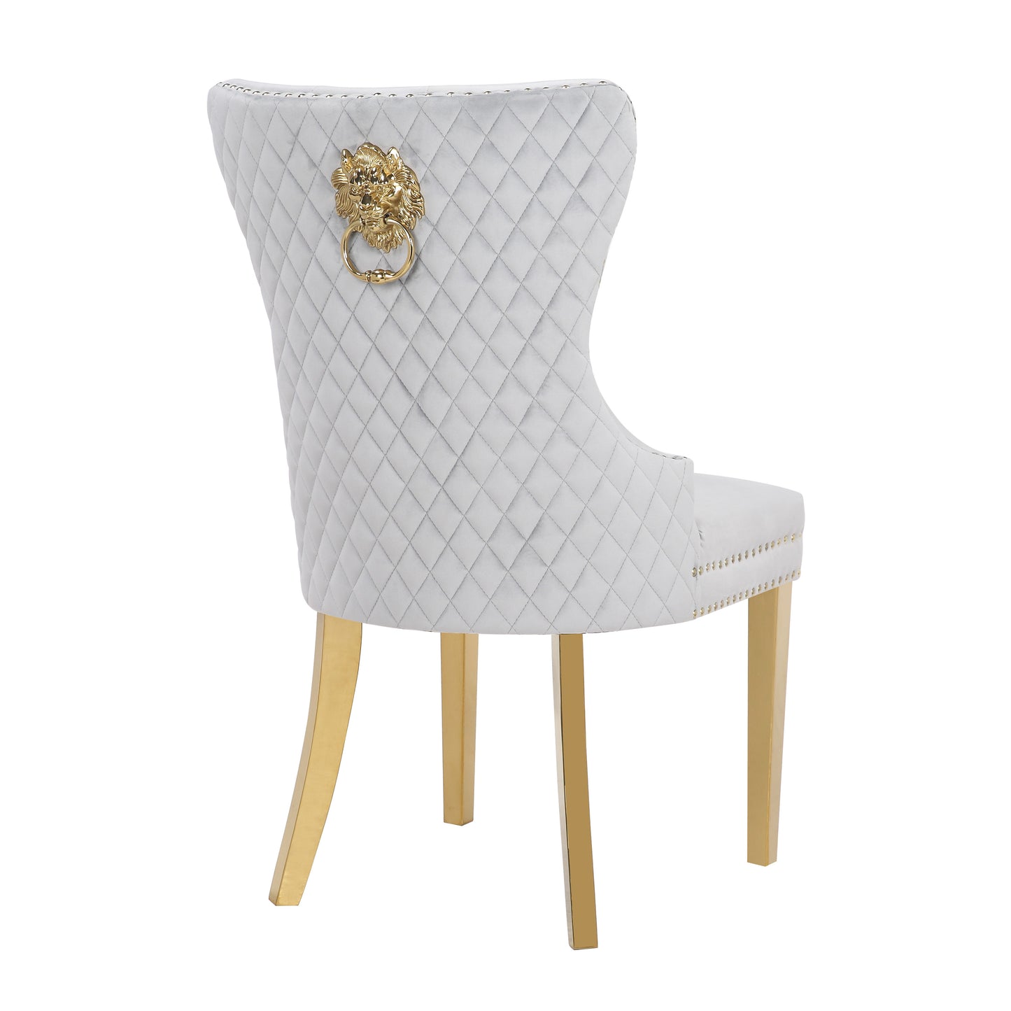 Grey velvet dining chair with diamond tufting and gold lion ring pull