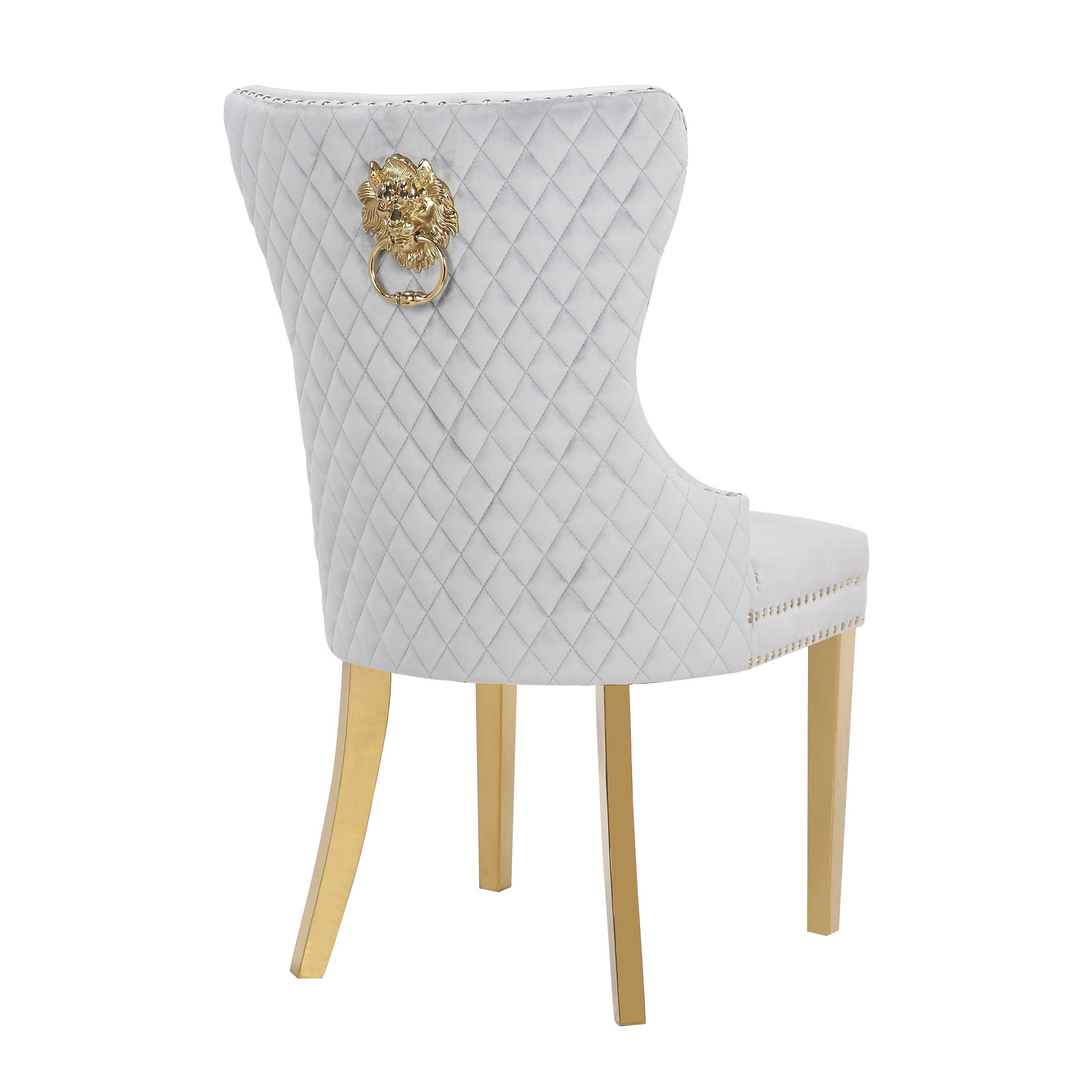 Grey velvet dining chair with diamond tufting and gold lion ring pull