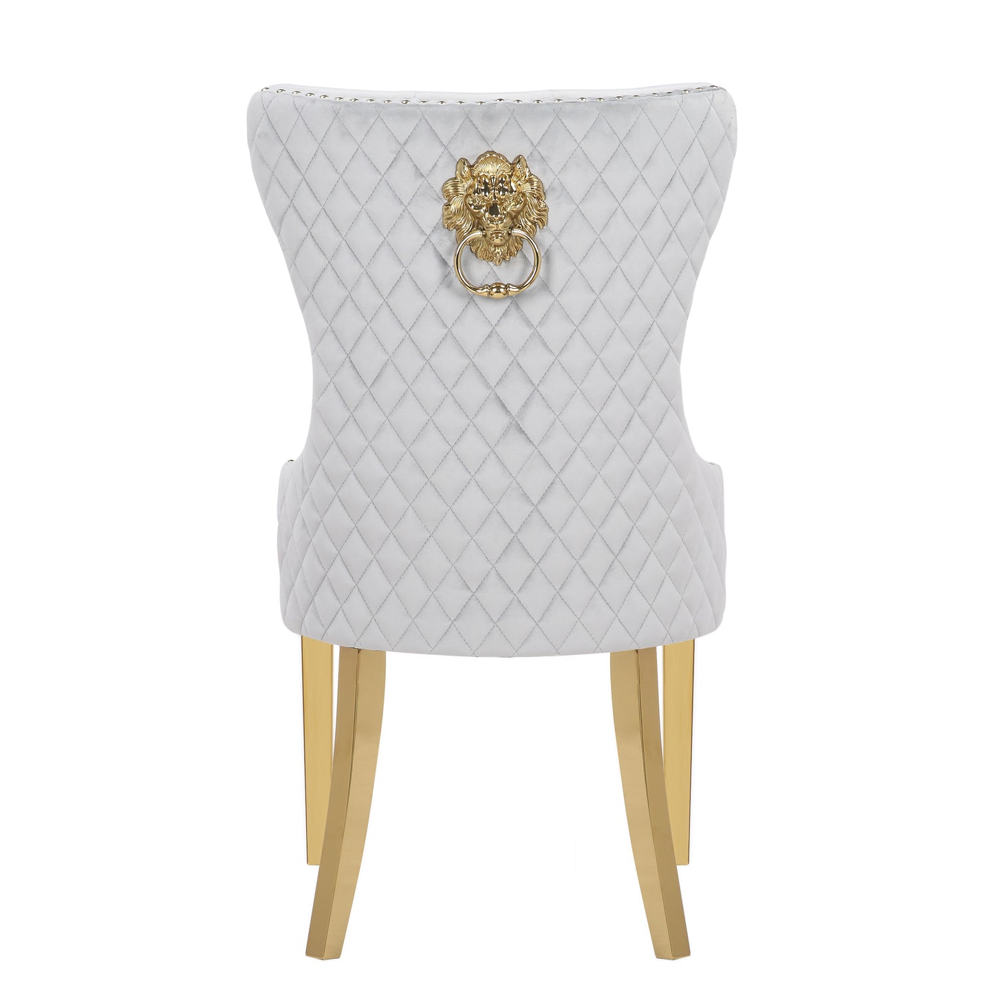 White velvet dining chair with diamond tufting and gold lion knocker hardware