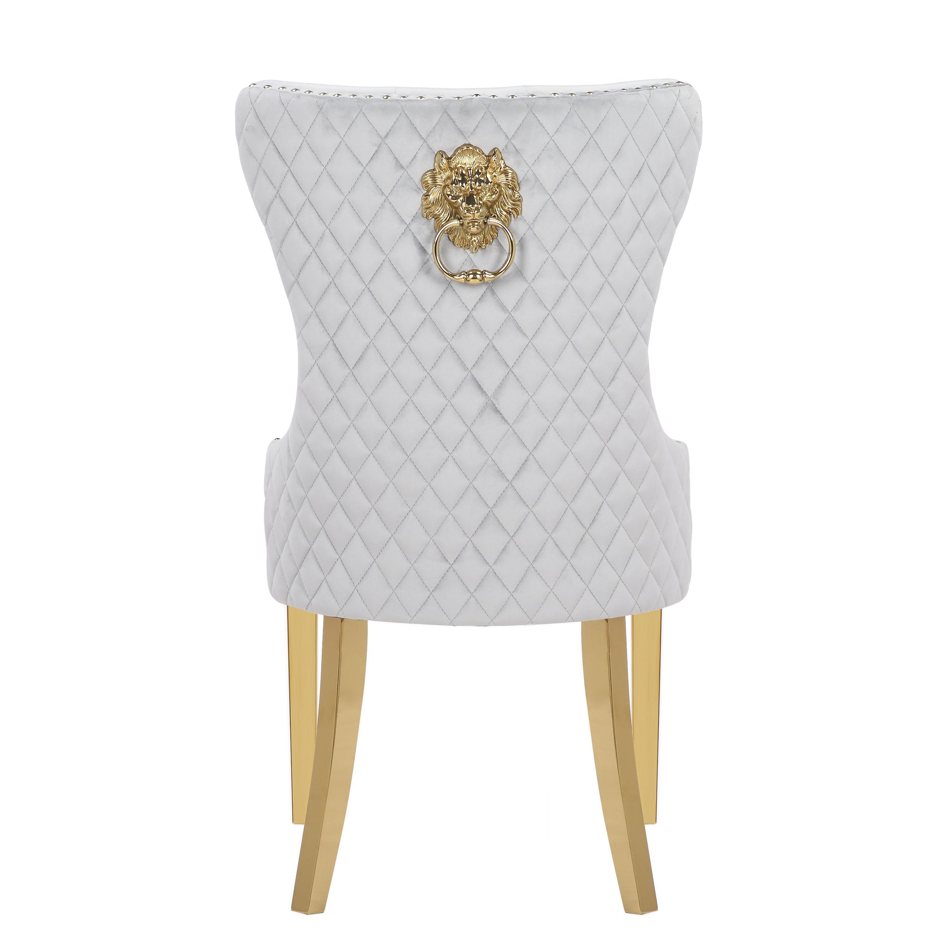 White velvet dining chair with diamond tufting and gold lion knocker hardware