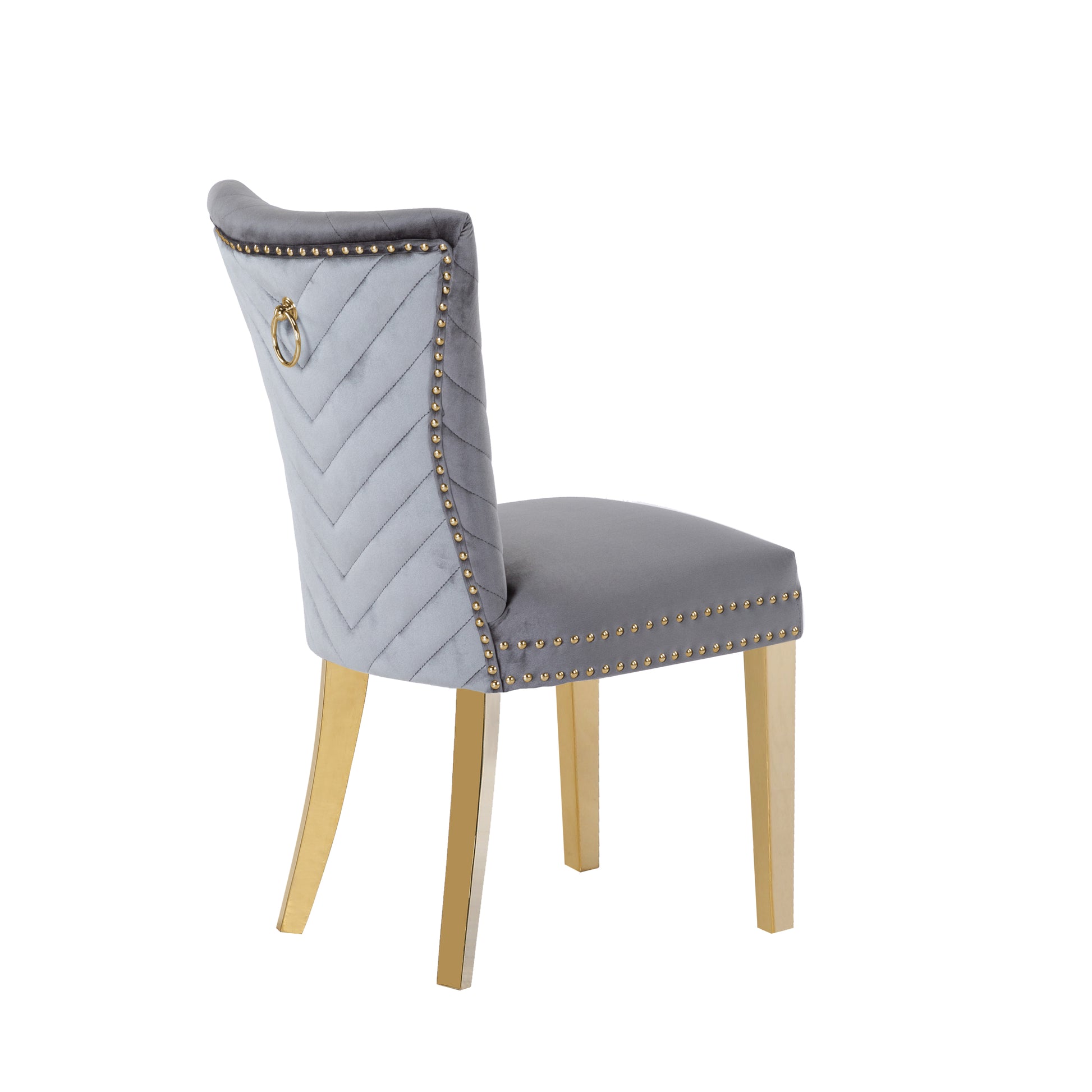 Light gray velvet dining chair with gold ring pull and brass legs tufted back