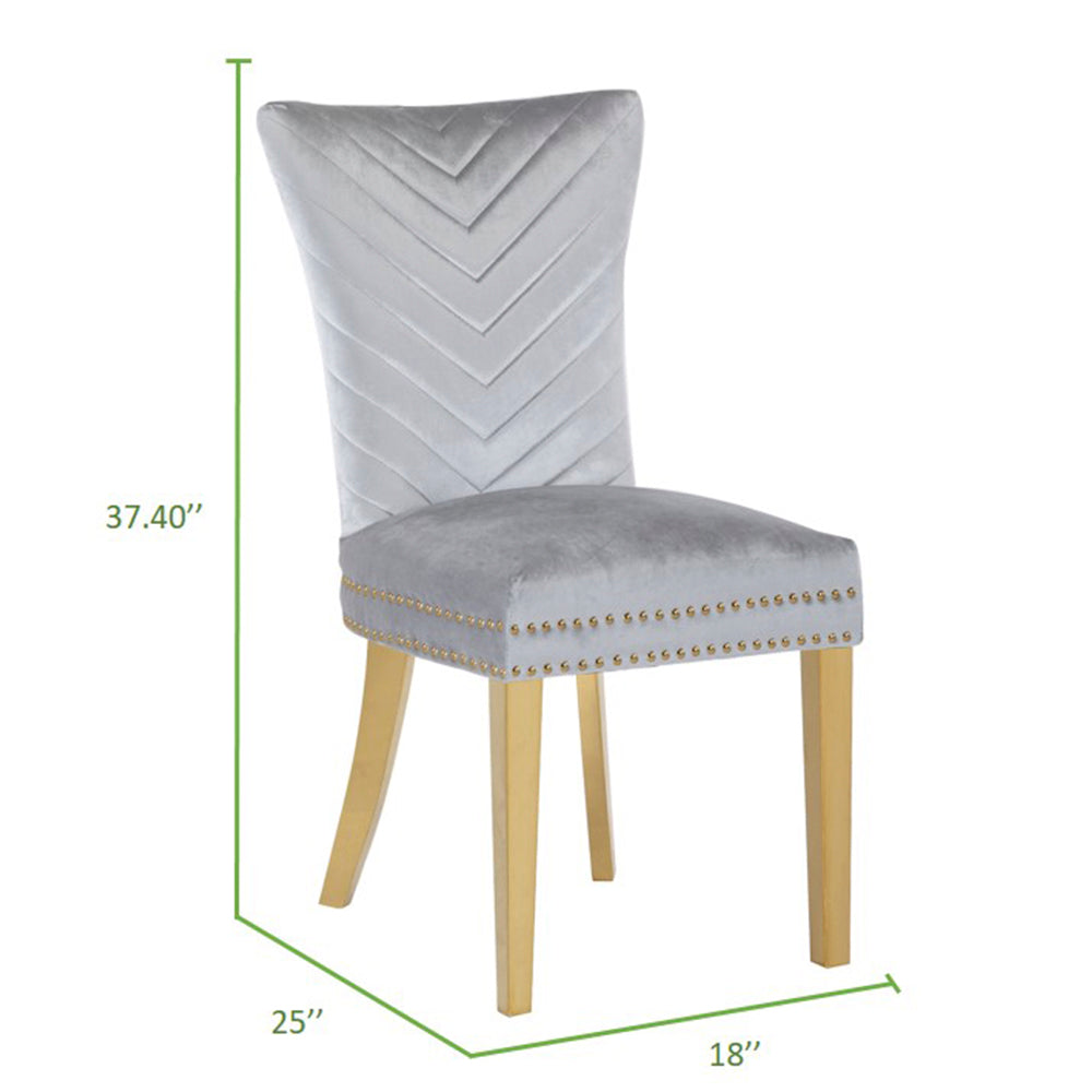 Light gray velvet dining chair with chevron back and gold nailhead trim