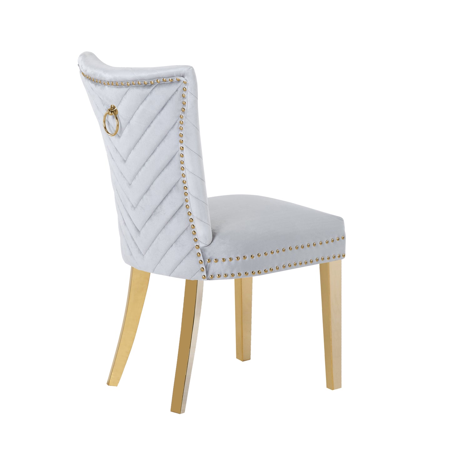 Light grey velvet dining chair with gold studded trim and ring pull accent