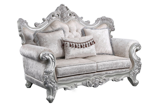 Ornate silver carved loveseat with embossed damask fabric and decorative tassels