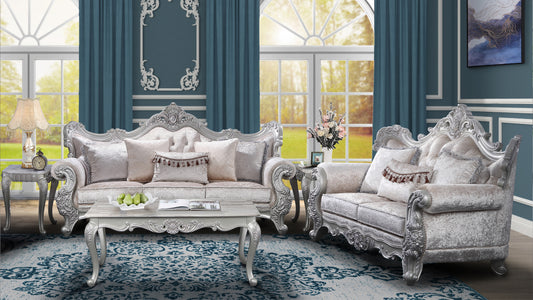 Luxurious silver carved sofa with plush velvet upholstery and ornate decorative pillows