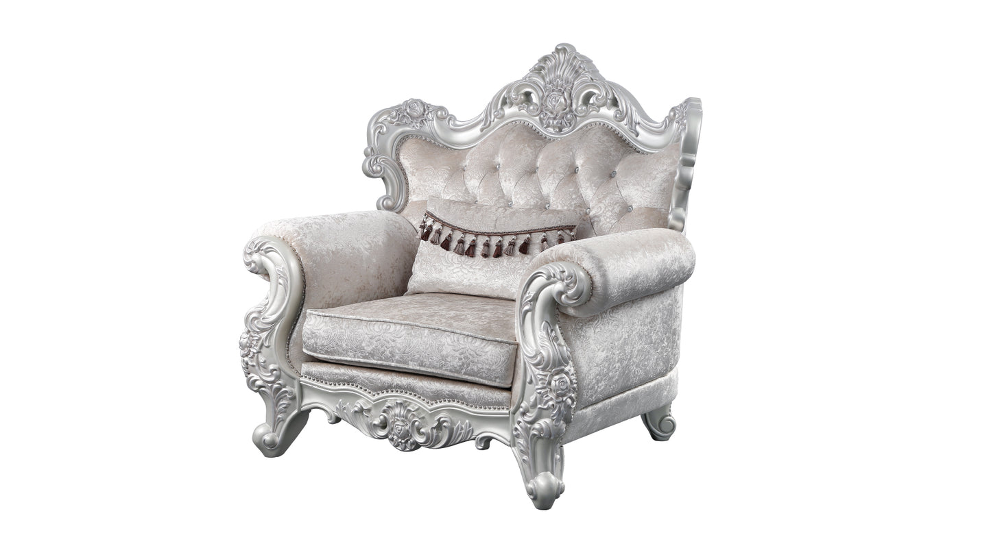Elegant silver and cream velvet armchair with ornate carvings and tufted back for luxurious seating