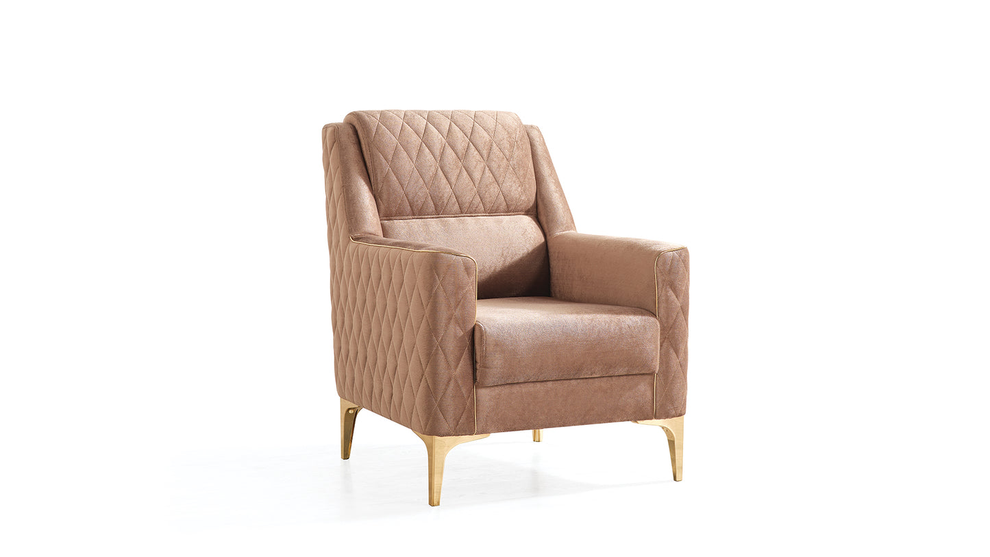 Tan upholstered armchair with diamond quilting and gold metal legs