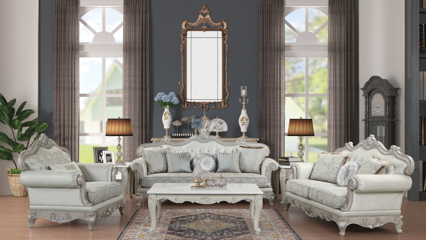 Ornate antique white sofa with ornate silver trim and plush throw pillows