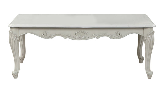 Ornate carved wooden coffee table with cabriole legs in antique white finish