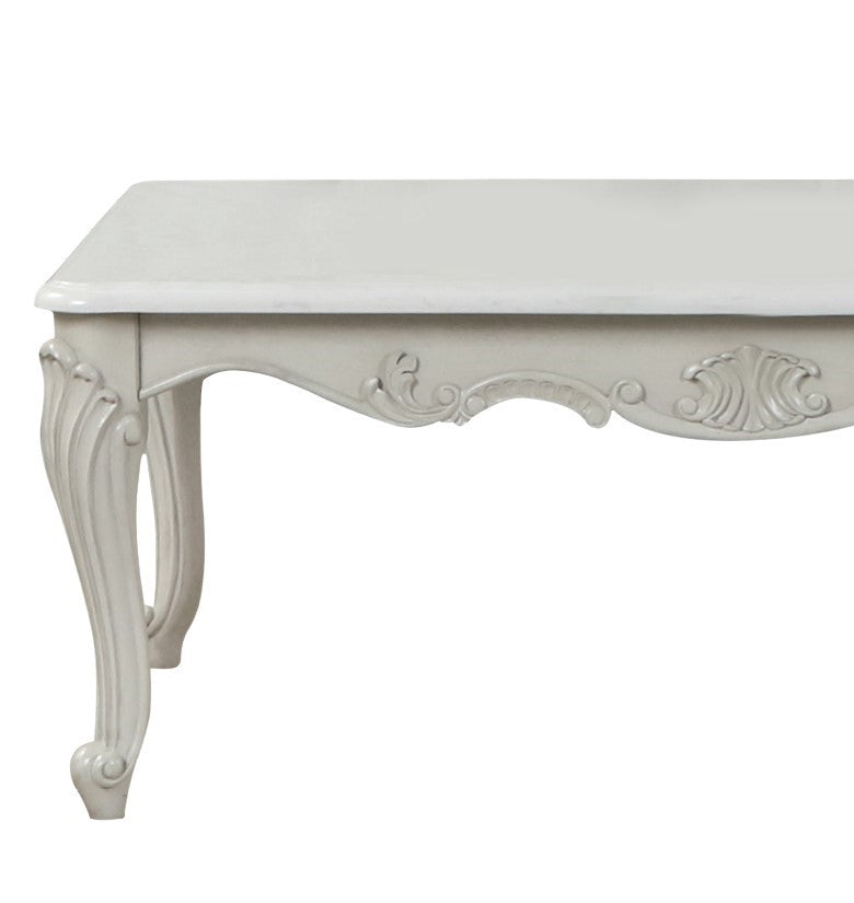 Elegant antique white console table with ornate carved legs and detailed trim