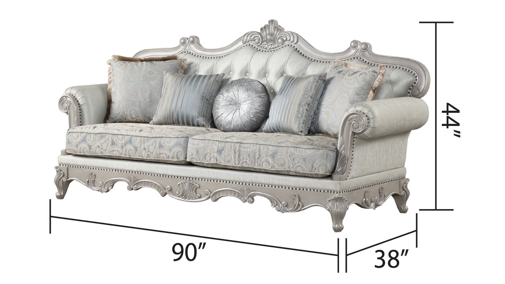 Ornate silver sofa with tufted back blue paisley cushions and decorative pillows