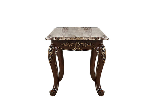 Ornate dark wood end table with a faux marble top and carved gold accents