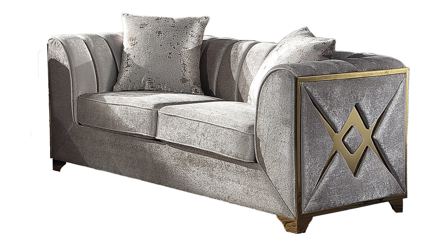 Elegant grey velvet sofa with golden geometric accents and plush cushions