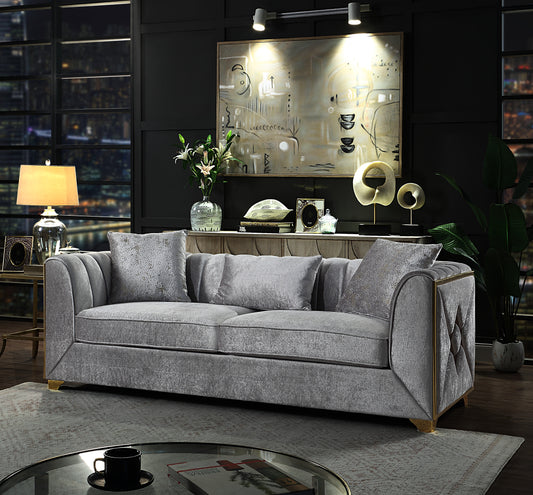 Plush grey velvet sofa with channel tufting and gold trim accents