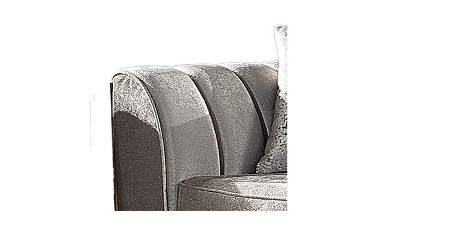 Closeup of plush silver velvet sofa armrest with channel tufting detail