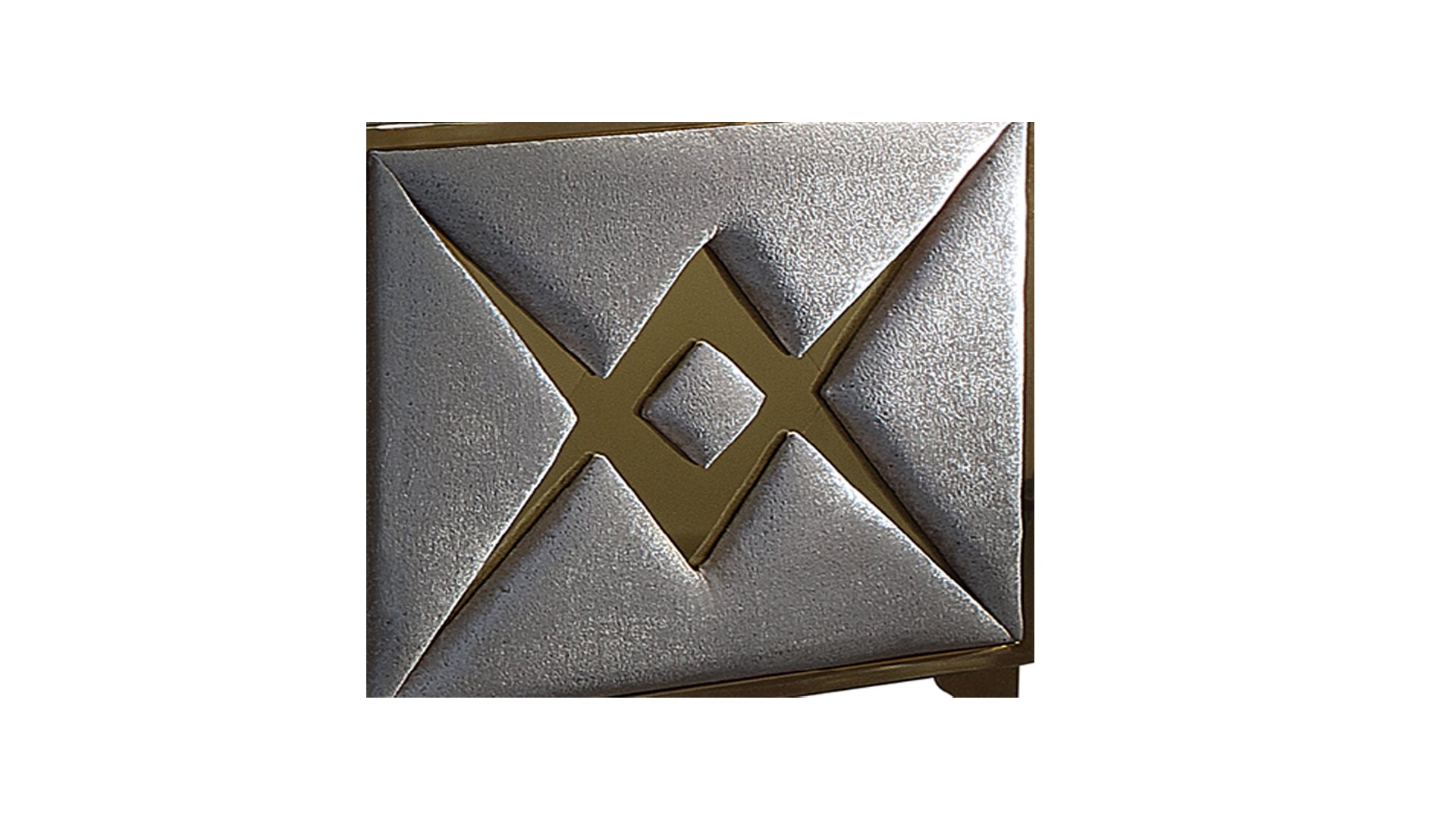 Silver embossed inlay with gold geometric accents on furniture panel