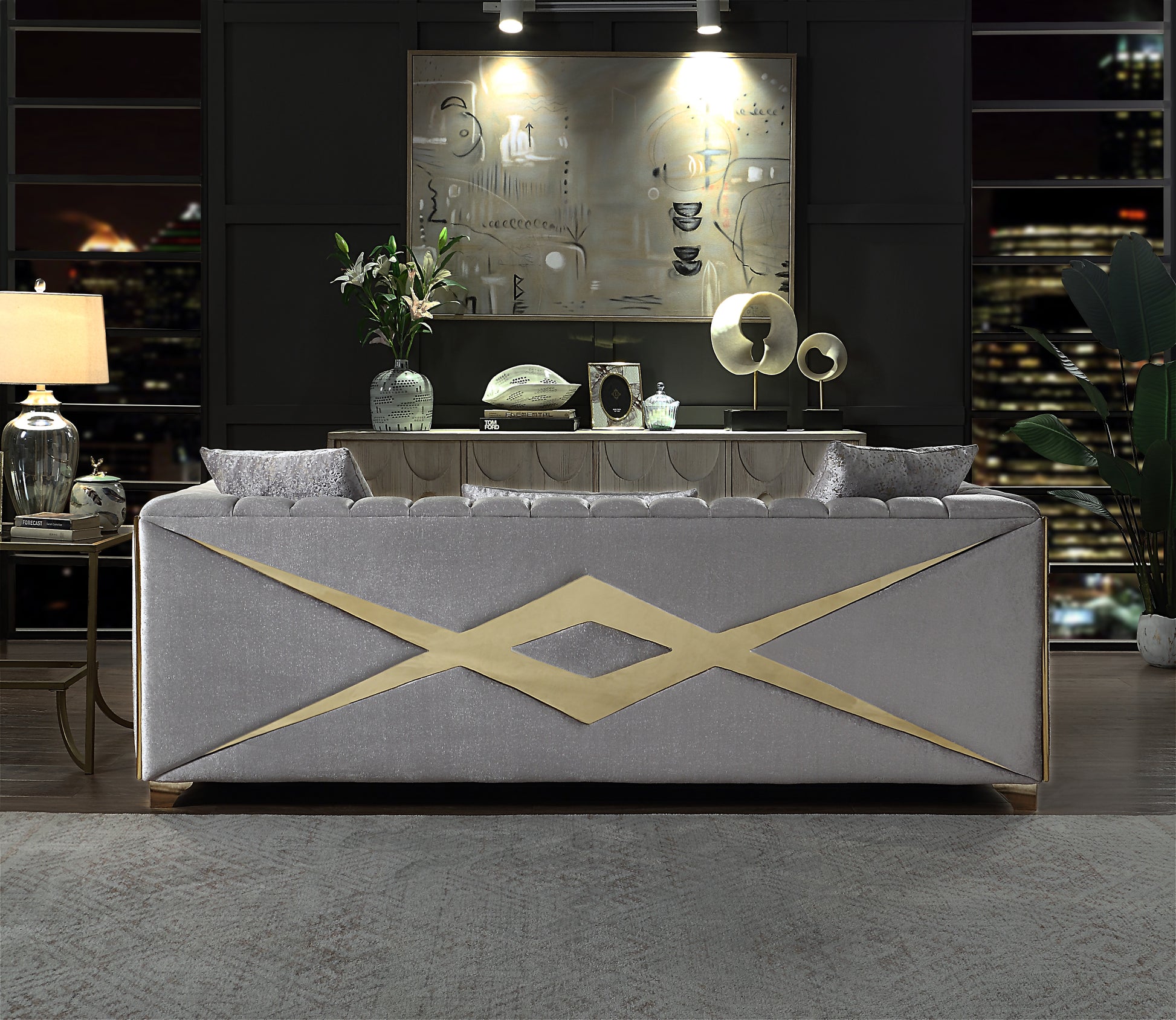 Elegant grey velvet sofa with gold geometric accents perfect for modern living rooms