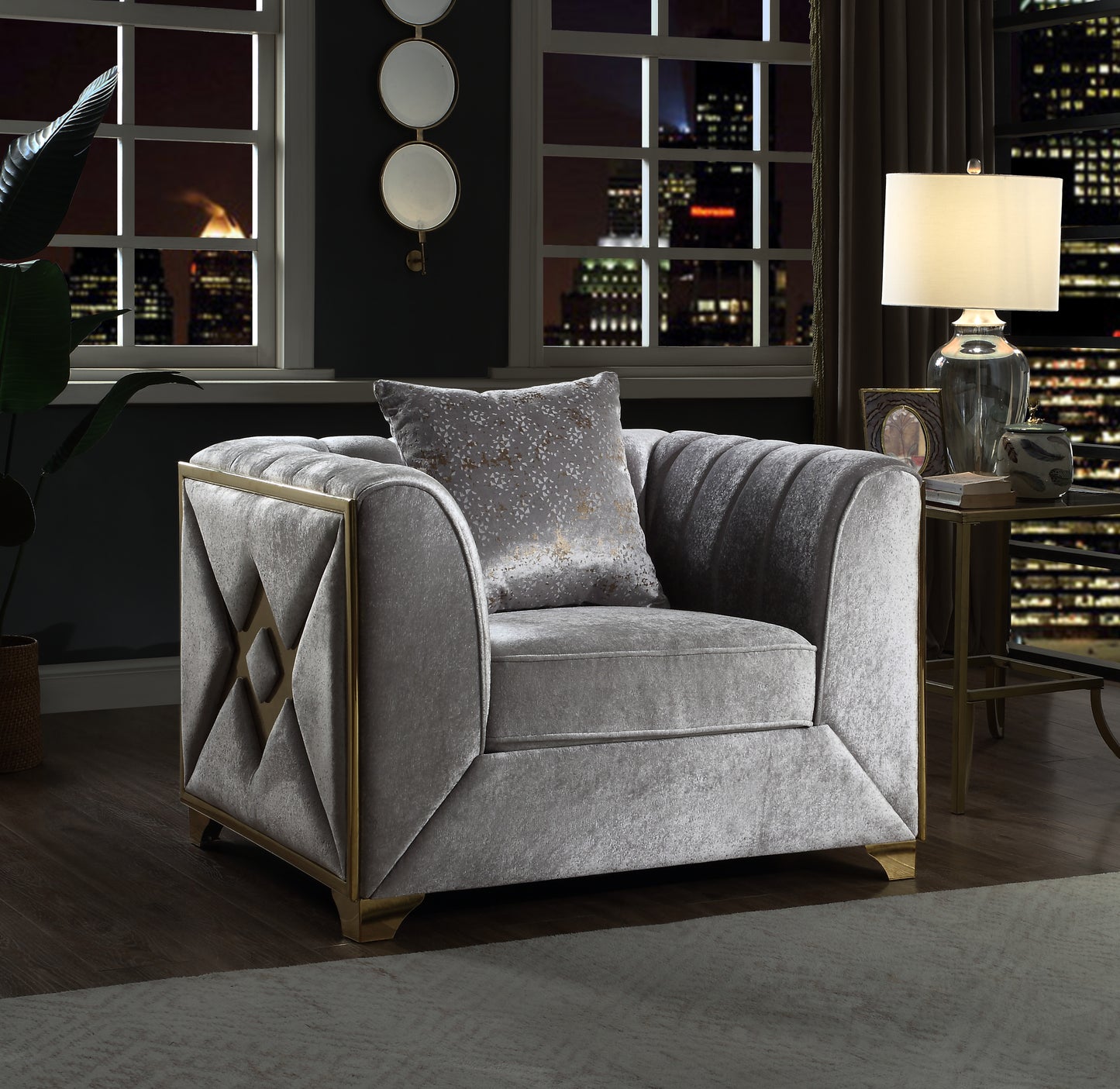 Tufted grey velvet armchair with gold geometric accents and matching pillow