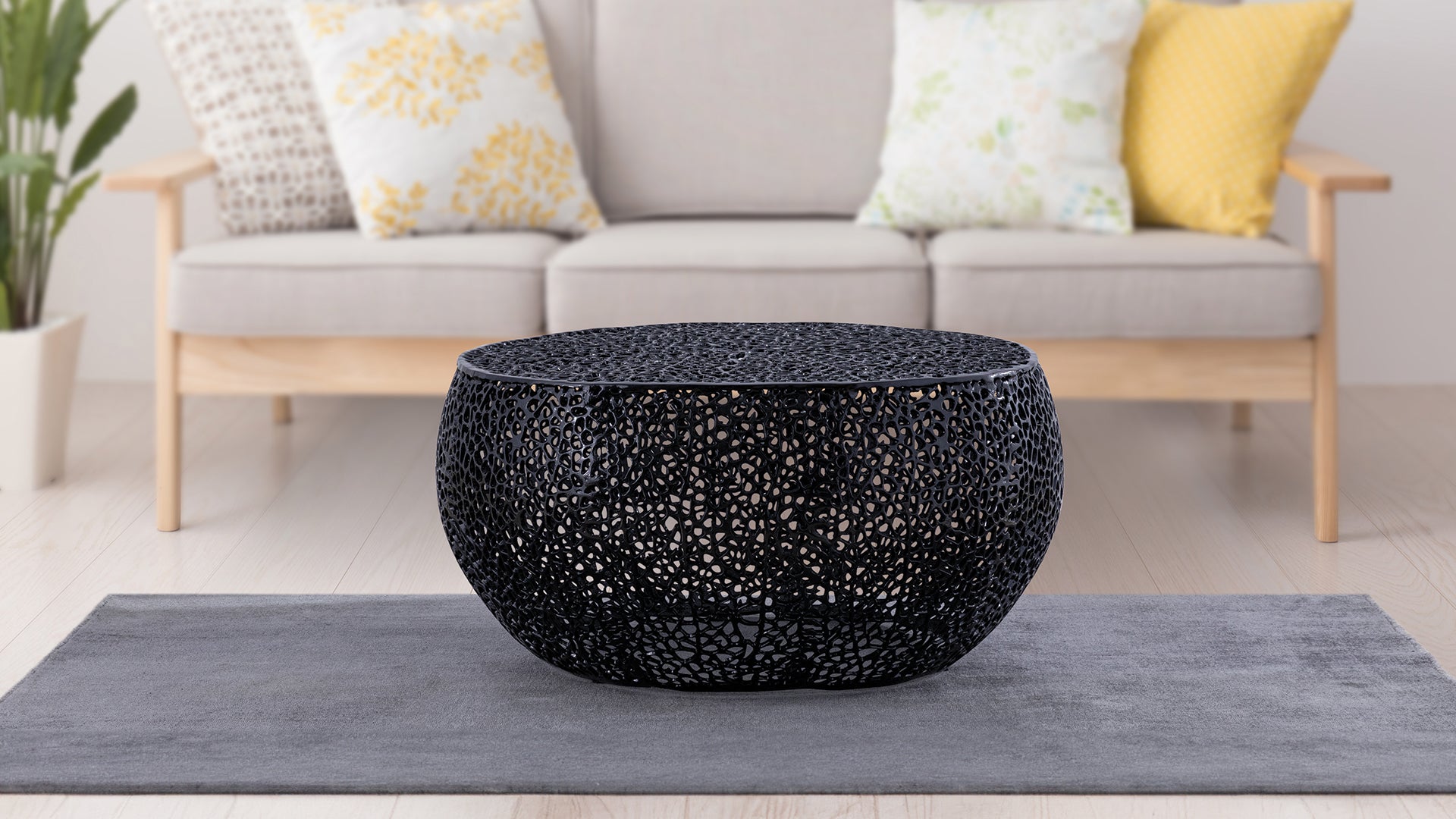 Round black metal coffee table with intricate lacelike pattern modern accent furniture