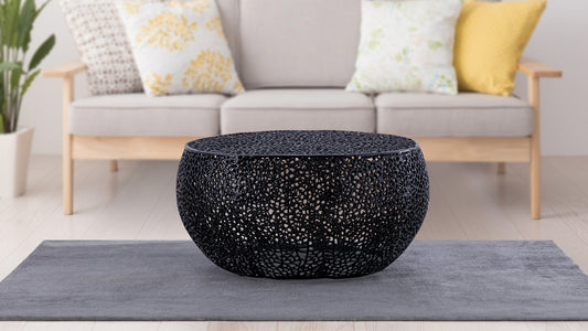 Round black metal coffee table with intricate lacelike pattern modern accent furniture