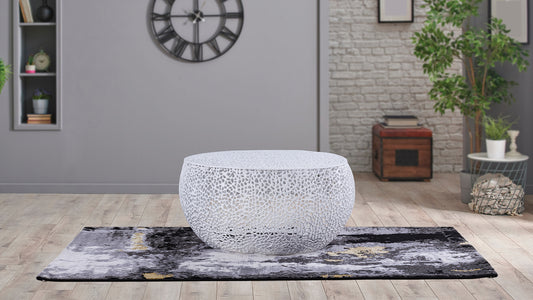 Round white metal coffee table with intricate cutout pattern modern design