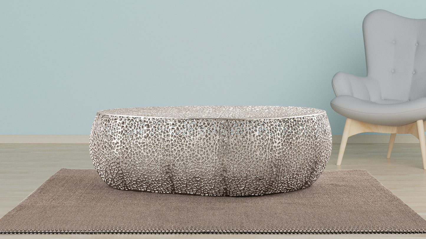 Round metallic coffee table with intricate cutout design