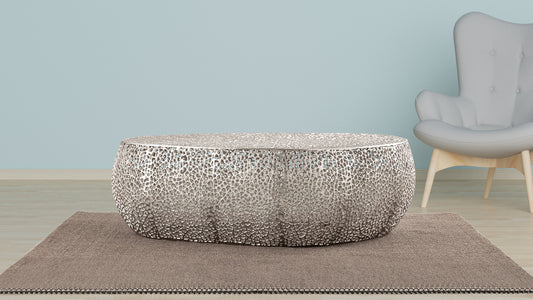 Round metallic coffee table with intricate cutout design