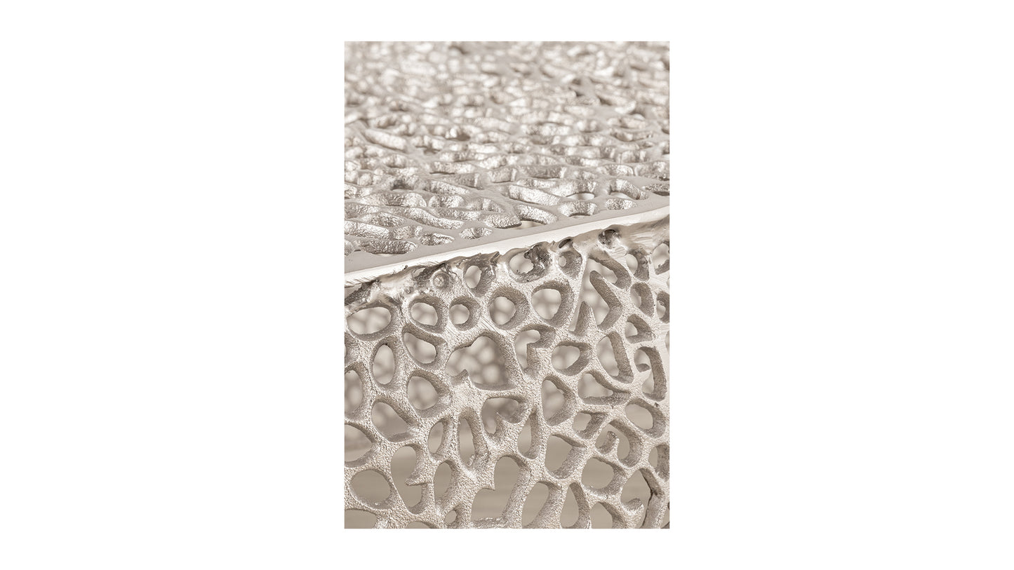 Textured silver side table with organic porous design