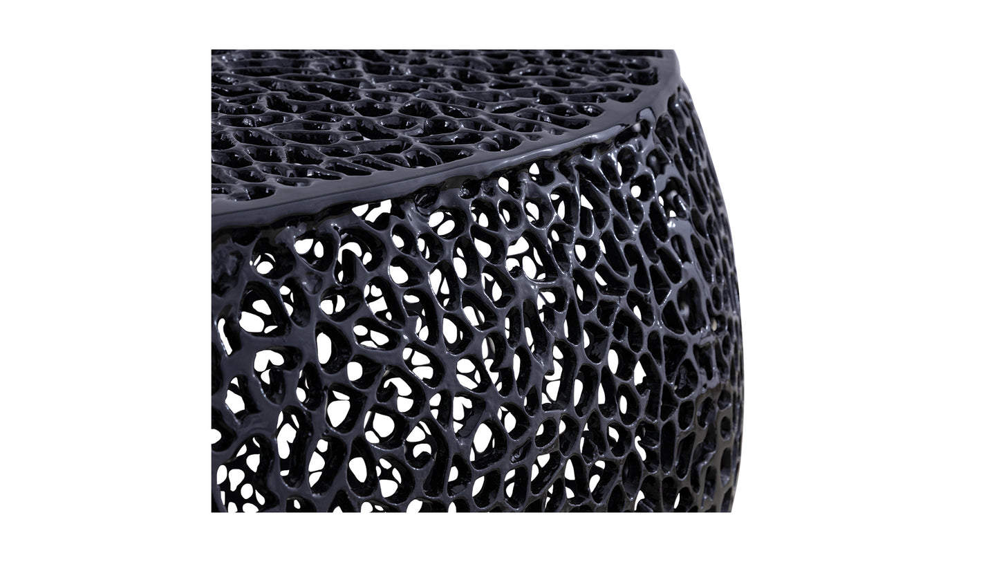 Glossy black abstract modern side table with a porous design