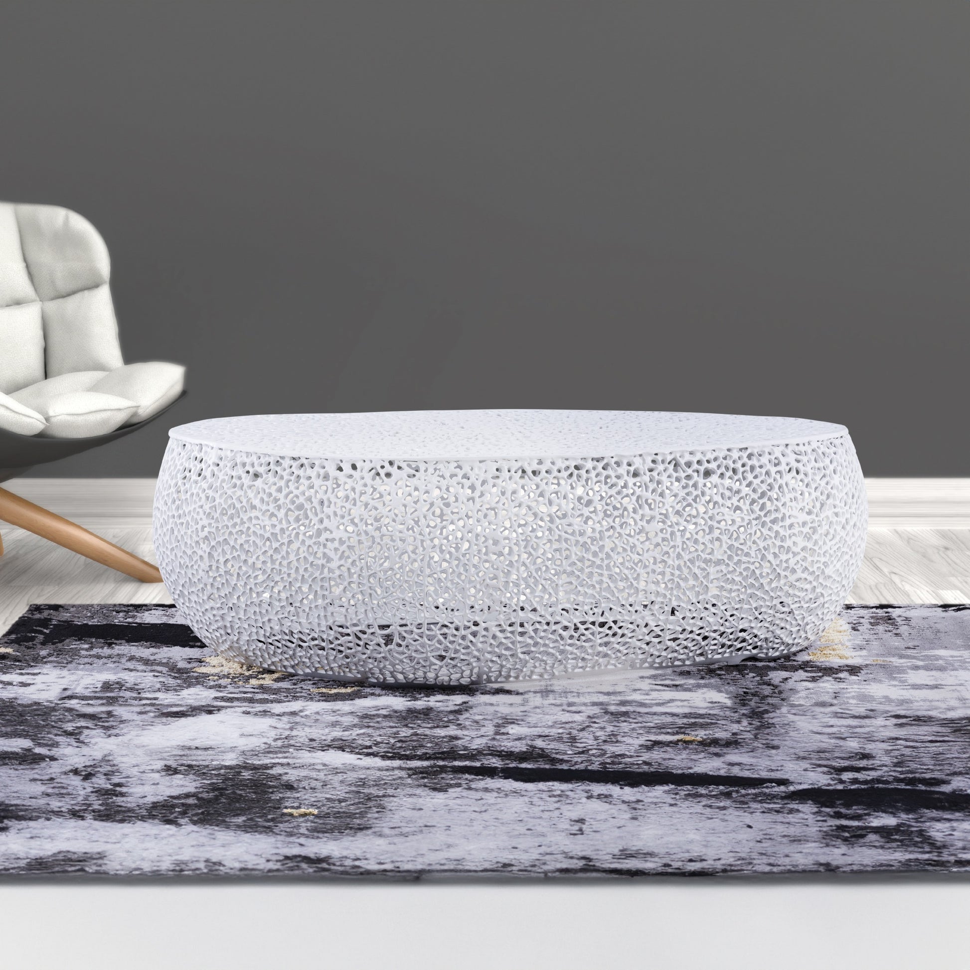 White modern sculptural coffee table with intricate cutout pattern chic living room centerpiece