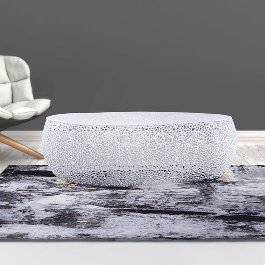 White modern sculptural coffee table with intricate cutout pattern chic living room centerpiece