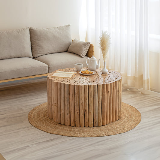 Rustic log coffee table with open book and white teapot set
