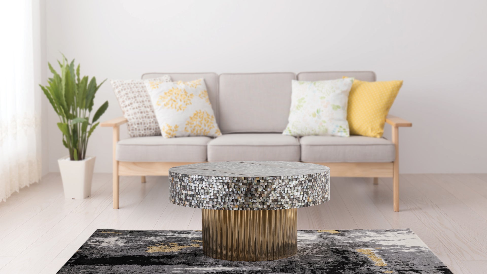 Circular mosaic coffee table with a fluted gold base on a grey and gold abstract rug