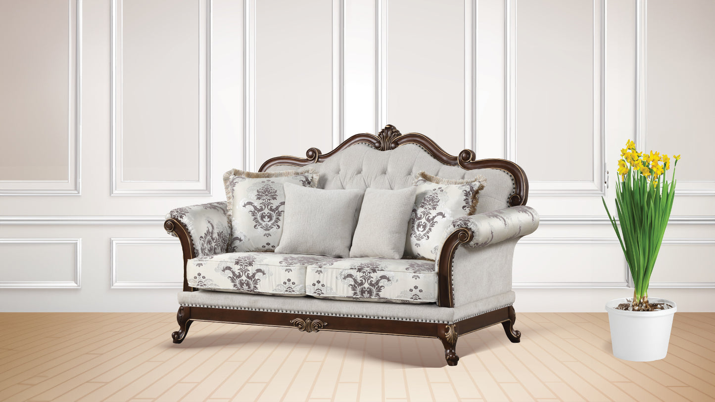Victorian style love seat with ornate wood trim and damask patterned upholstery