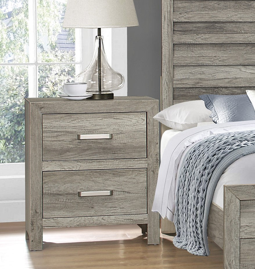 Rustic gray wood nightstand with two drawers and silver handles beside bed