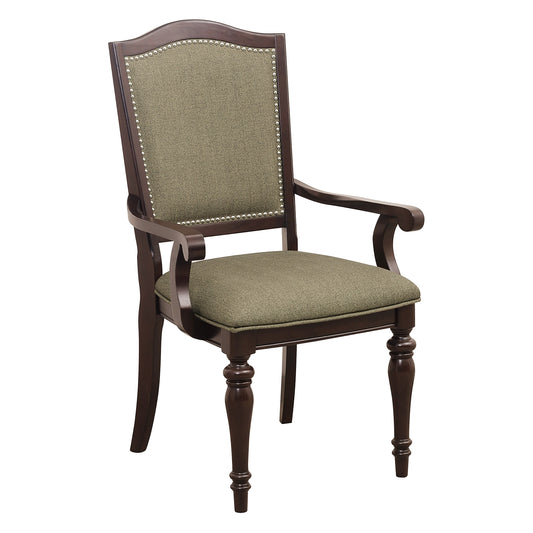 Dark wood upholstered dining chair with nailhead trim and green fabric seat